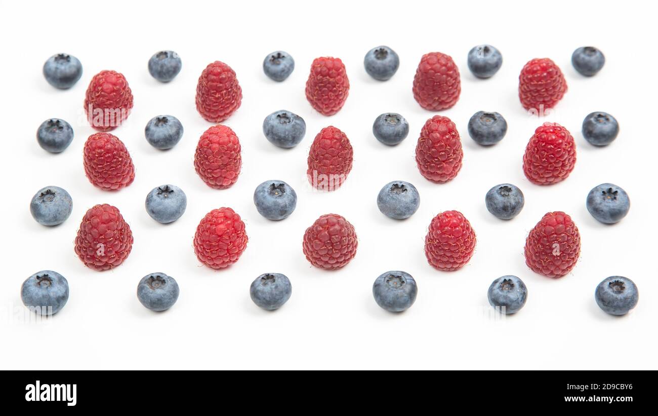 raspberries and blueberries on a white background. Vitamins and