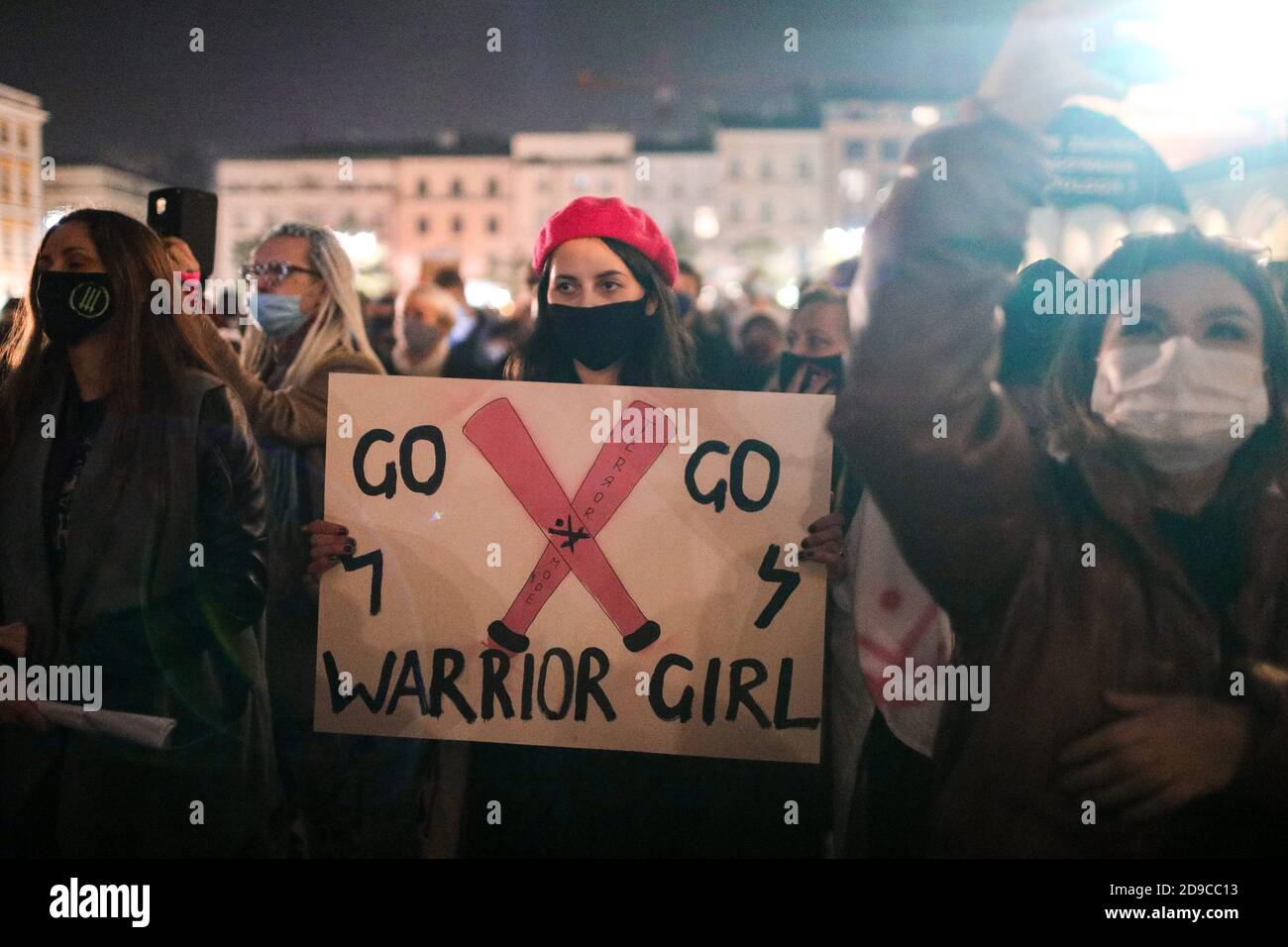 A protester holding a placard saying 'Go, go, warrior girl'  The Polish Constitutional Court in its new, politically chosen courthouse ruled that abor Stock Photo