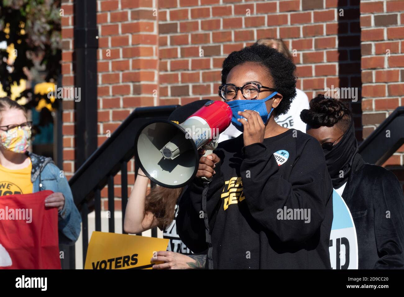 A protester speaking to colleagues through a megaphone during the demonstration.Dozens gather in Erie, Pennsylvania's Perry Square Park to demand that their votes be counted in the still contested 2020 presidential election. The inordinately high number of absentee ballots and early votes means that Pennsylvania, a key battleground state--may be counting votes until Friday. Stock Photo