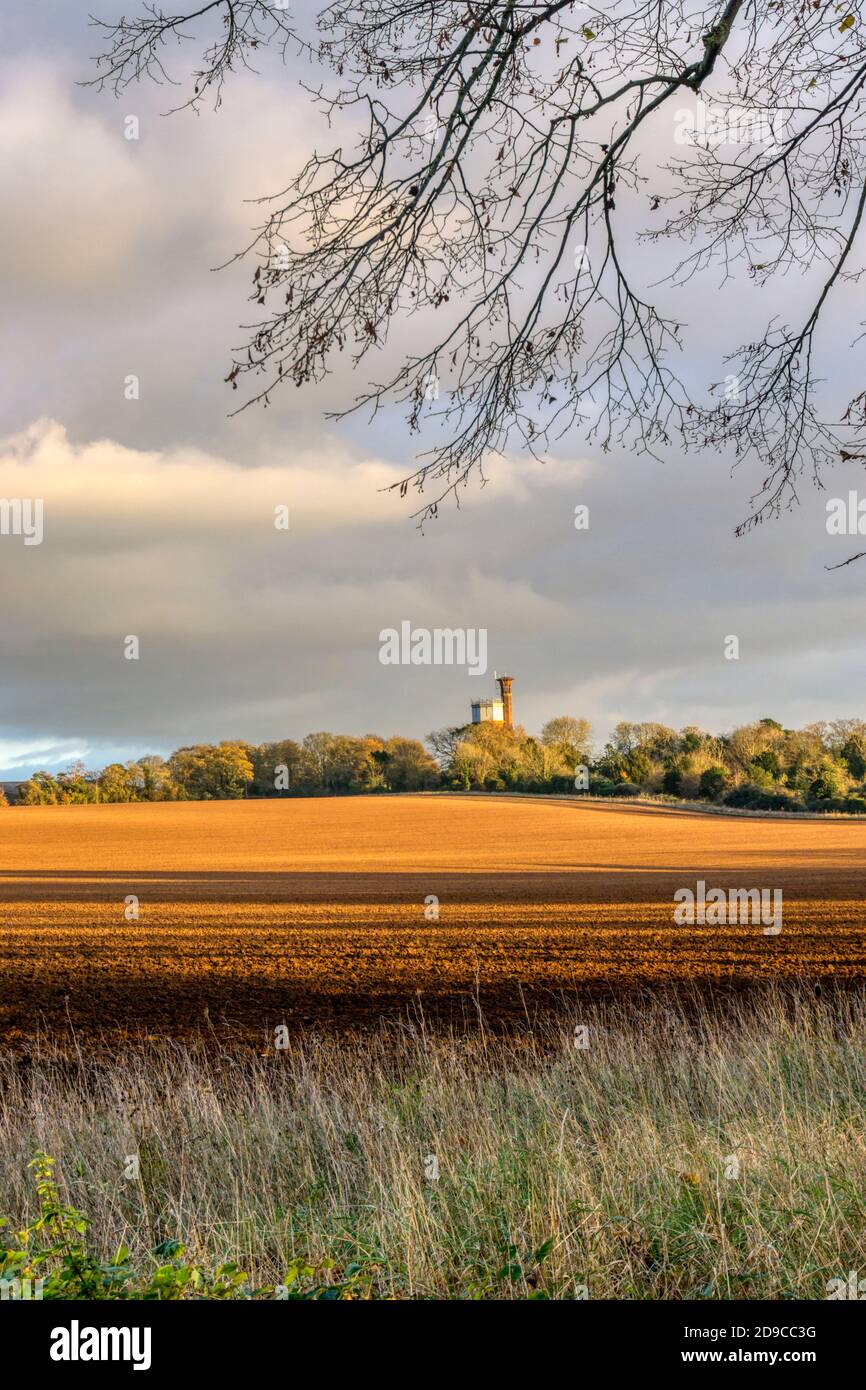 Norfolk autumn landscape near West Newton on the Sandringham estate. Appleton Victorian water tower in distance, now a holiday-let. Stock Photo