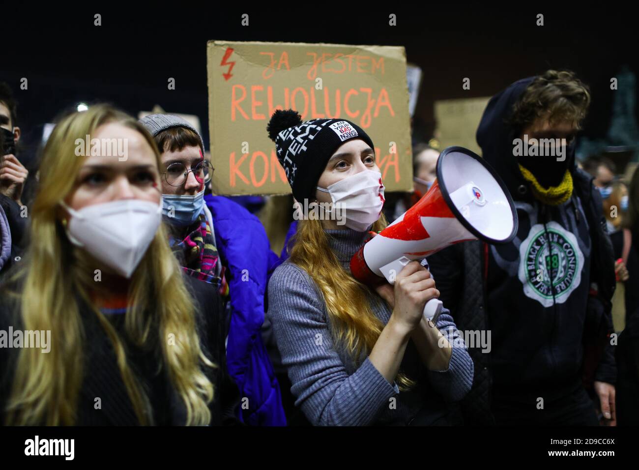 A woman holding a bullhorn seen among the crowd of protesters.  The Polish Constitutional Court in its new, politically chosen courthouse ruled that a Stock Photo