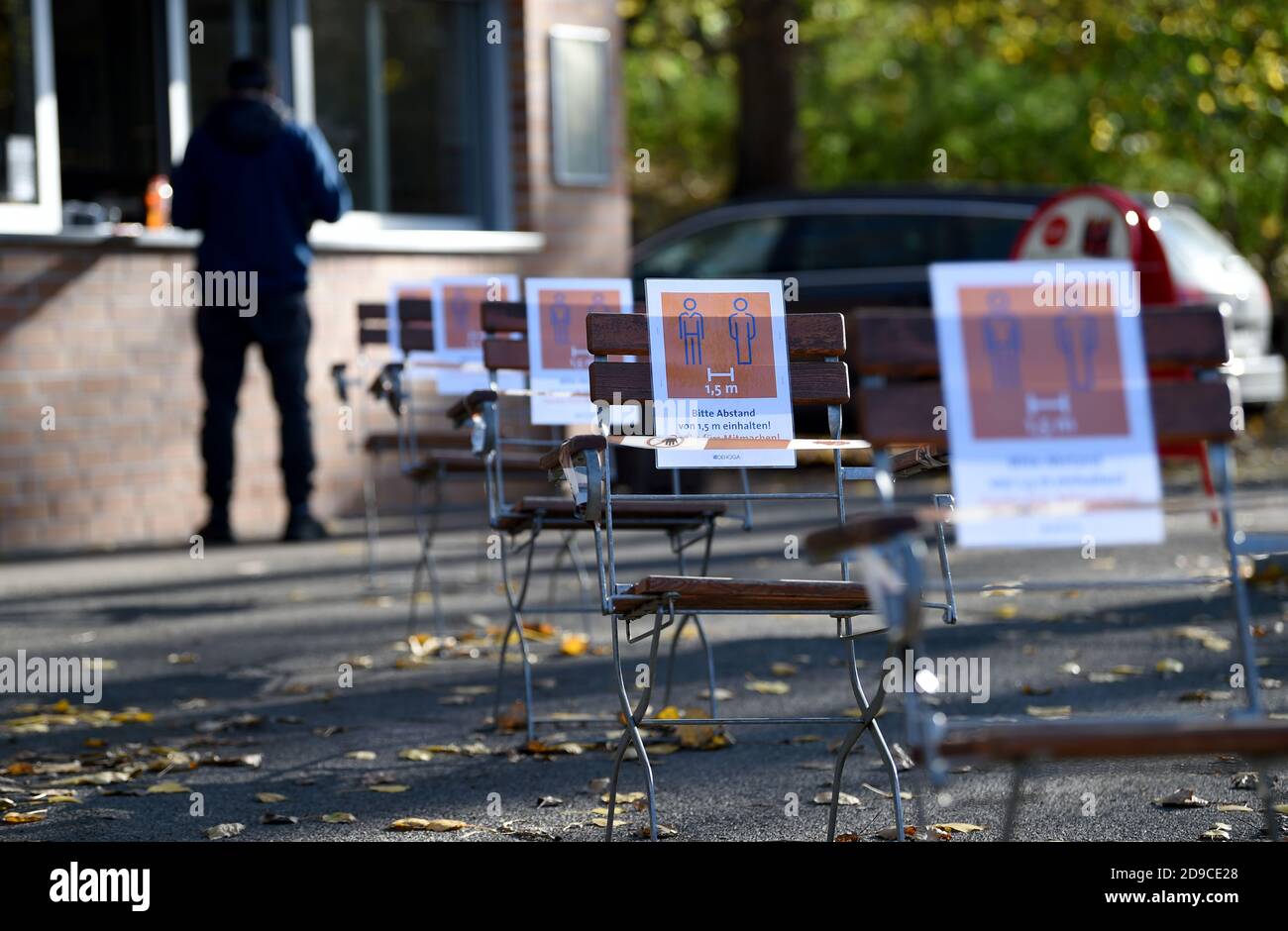 Berlin, Germany. 04th Nov, 2020. At a snack bar there are chairs with signs saying '1.5 m, please keep a distance of 1.5 m'. By placing them, they indicate the safety distance in the queue. Federal and state governments have decided on a partial lockdown. Credit: Kira Hofmann/dpa-Zentralbild/dpa/Alamy Live News Stock Photo