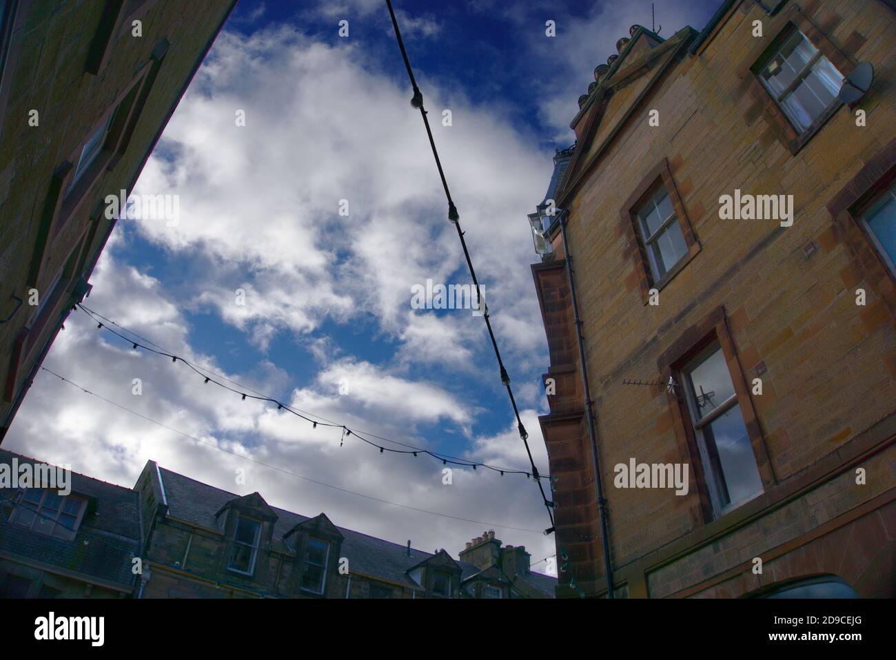 Lights and wiring silhouetted against the sky as seen from ground level at the corner of Channel Street, Galashiels, Scottish Borders, Scotland, UK. Stock Photo