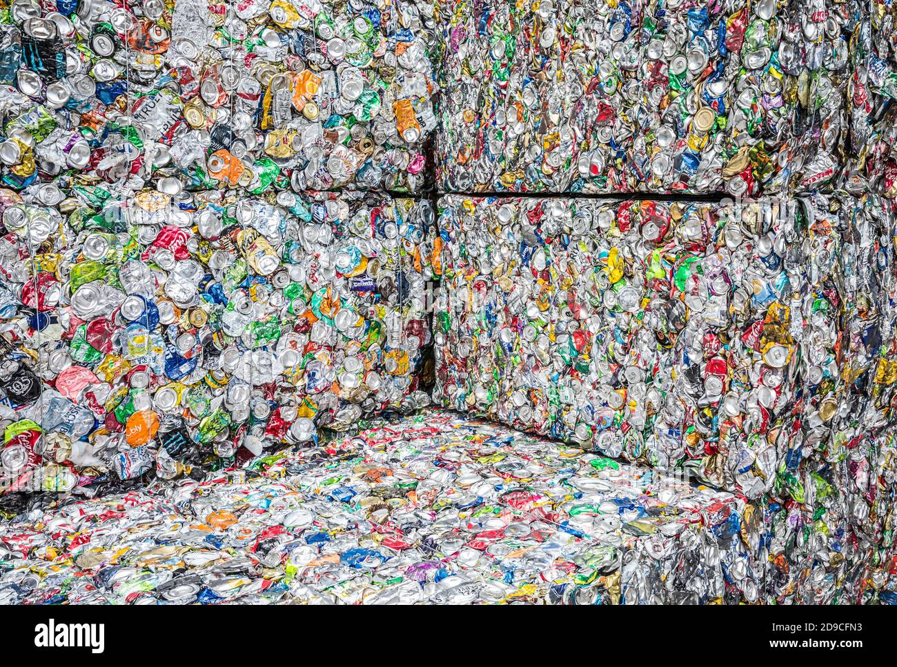 Stacked cubes or bales of aluminum cans crushed into blocks for recycling. Stock Photo