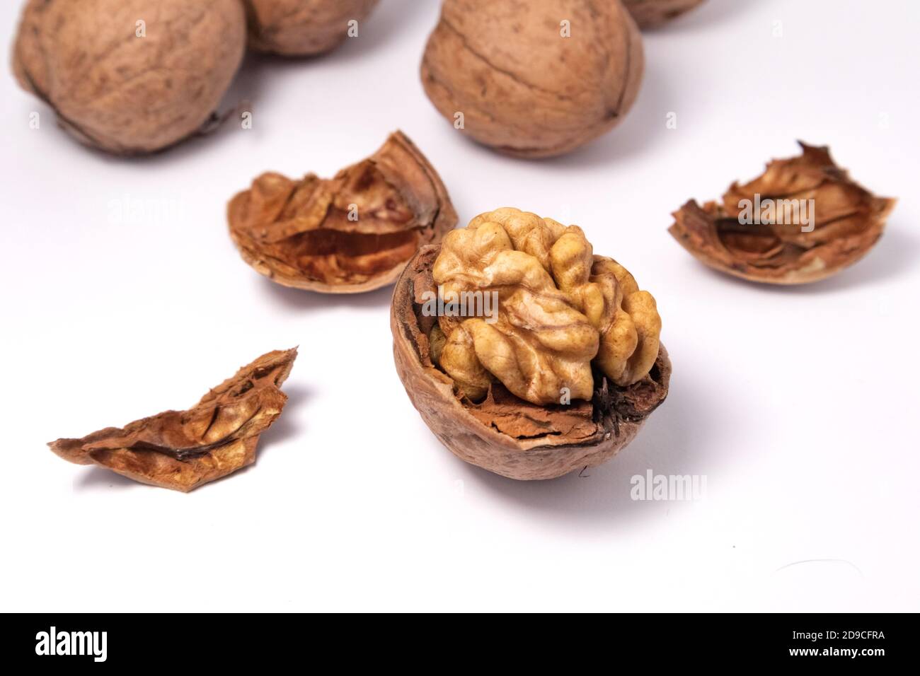 Walnuts isolated on white background. Walnut kernels and whole walnuts Stock Photo
