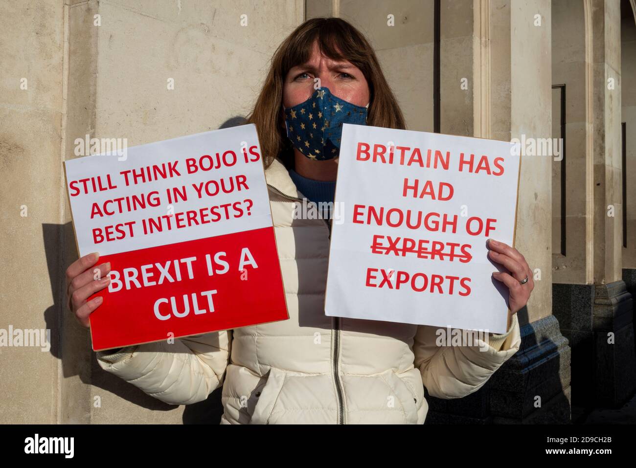 Female protester against Brexit holding placards in Westminster, London, UK. BoJo, Boris Johnson, Brexit is a cult. Britain has had enough Stock Photo