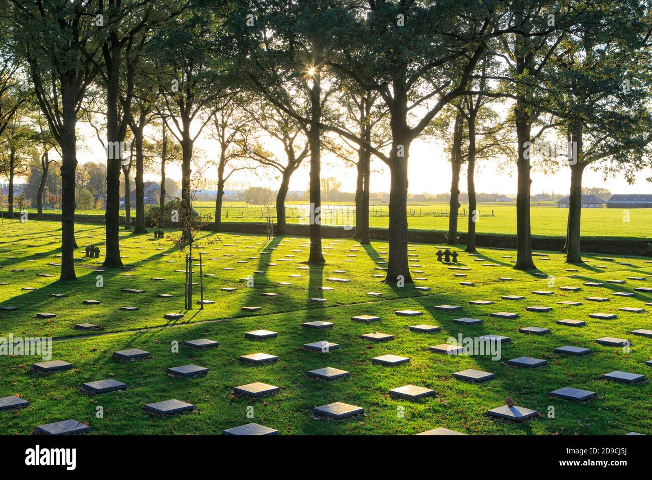 Stone crosses and World War I graves at Langemark German war cemetery at sunset in Langemark-Poelkapelle, Belgium Stock Photo