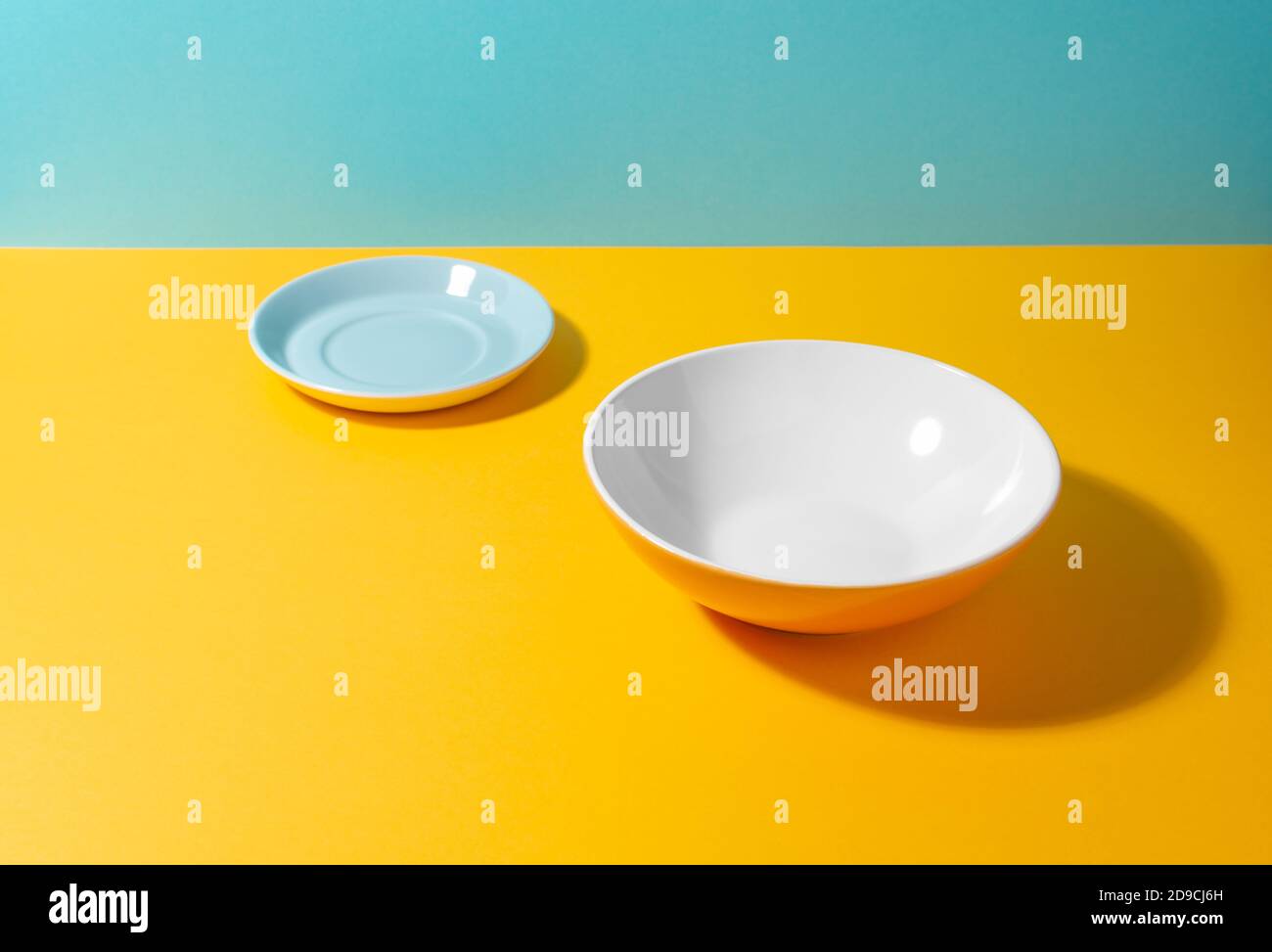 Set of a tea plate and a deep plate on colorful background with copy