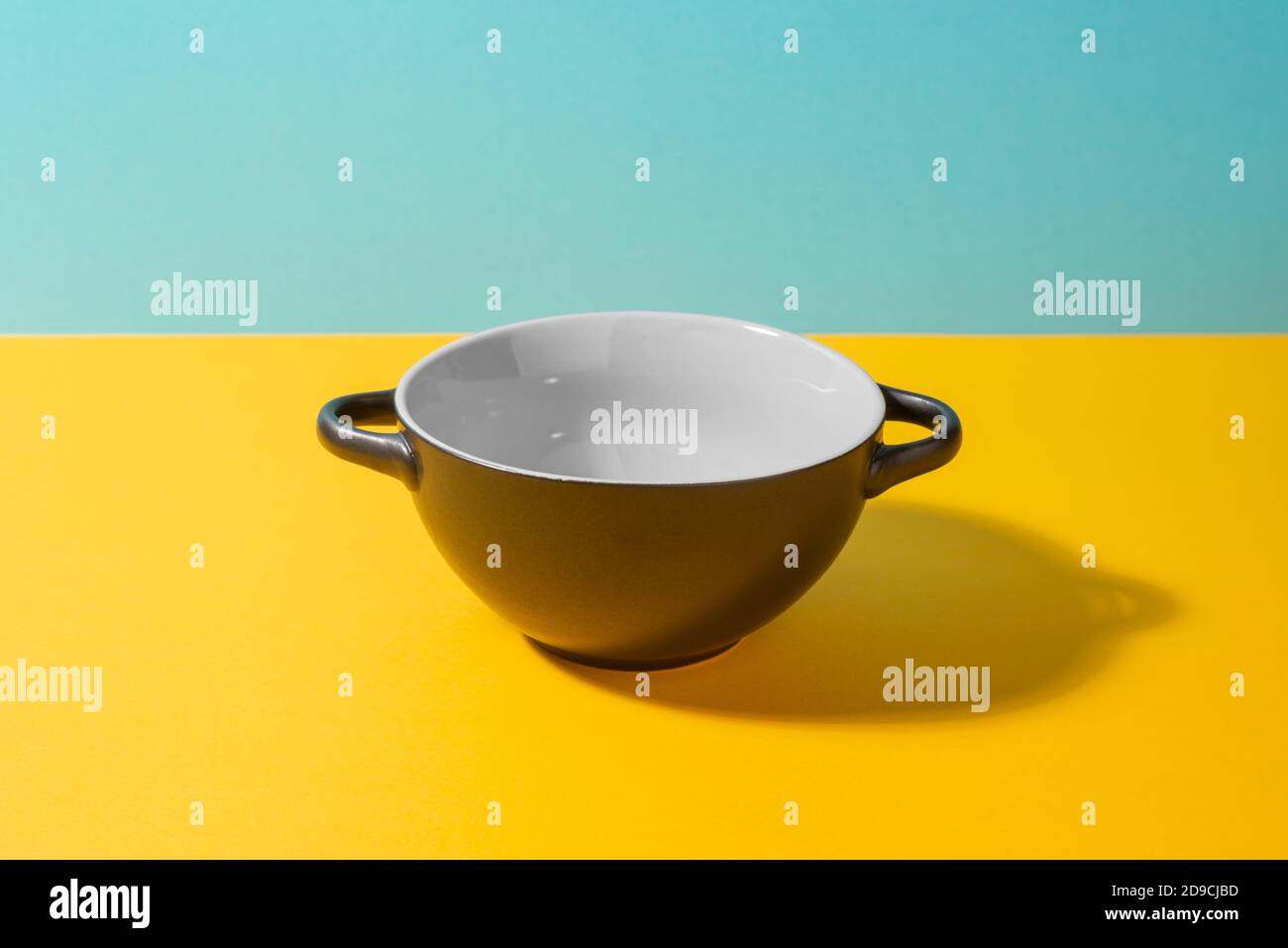 Black deep ceramic bowl on colorful background Stock Photo