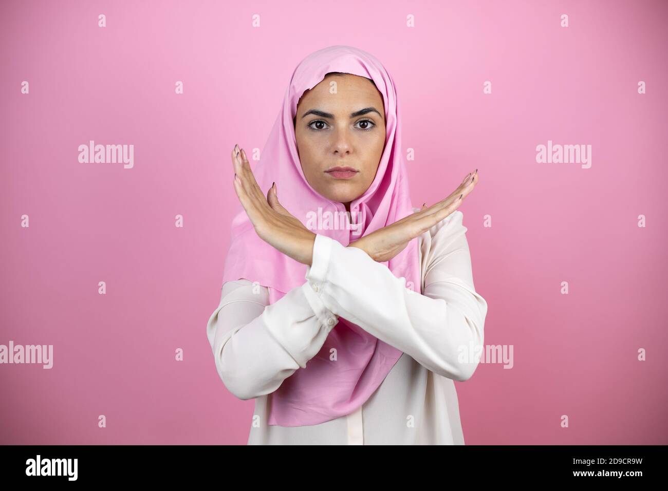 Young hispanic woman crossing fingers hi res stock photography and