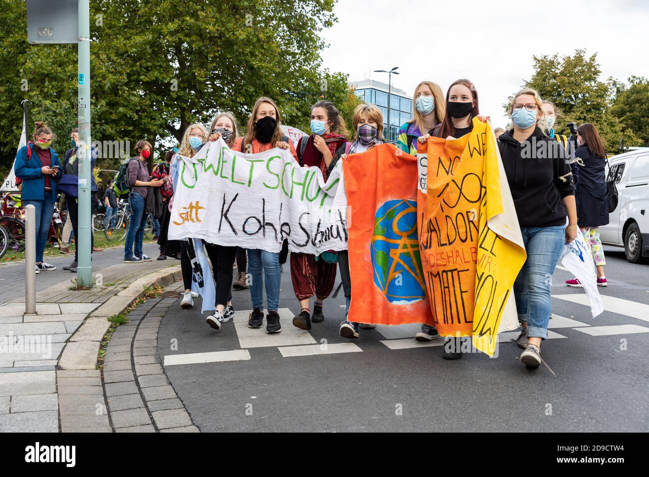 Gottingen, Germany. Autumn 2020. Fridays for future. Group of young women holding up banner marching against climate change. Stock Photo
