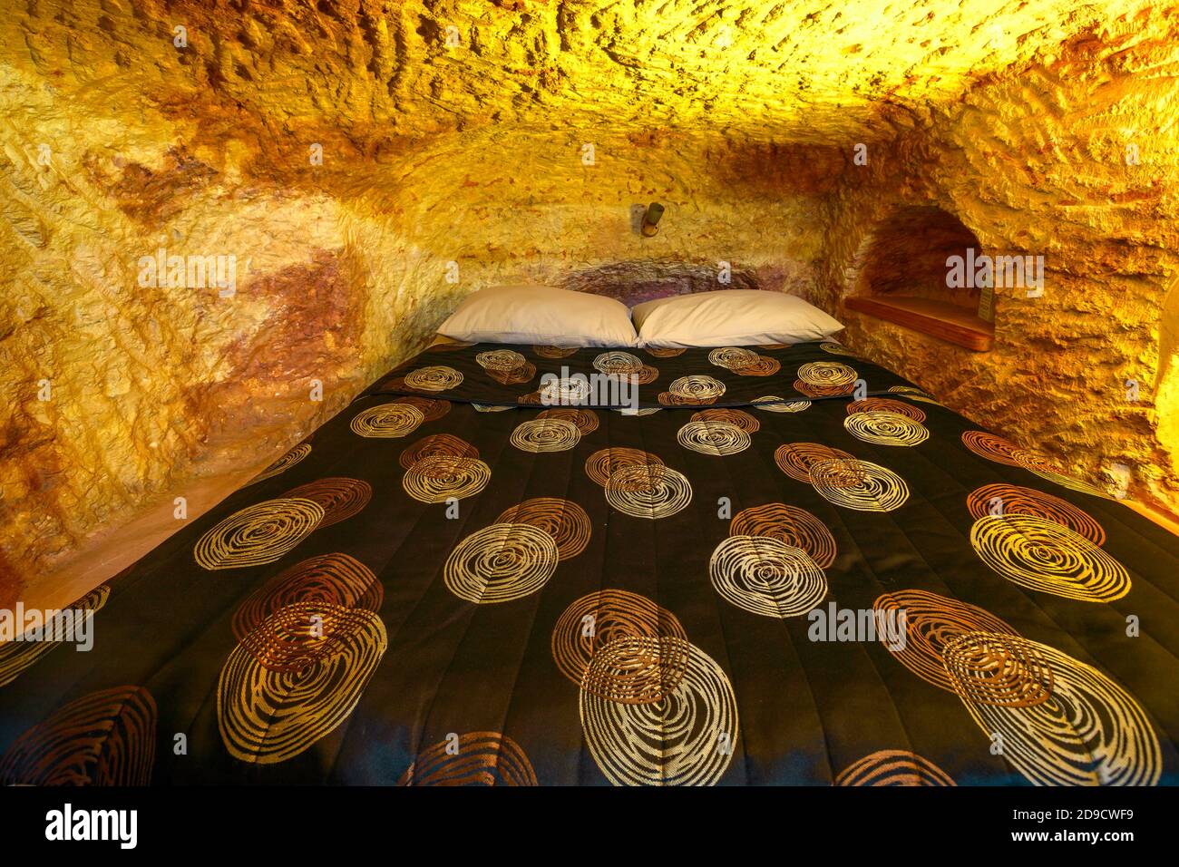 Coober Pedy, South Australia, Australia - Aug 28, 2019:Underground bed of an underground house carved in stone. Coober Pedy mining town of Australia Stock Photo