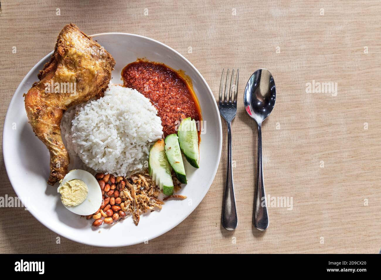 Simple nasi lemak with sambal fried chicken, popular in Malaysia Stock Photo