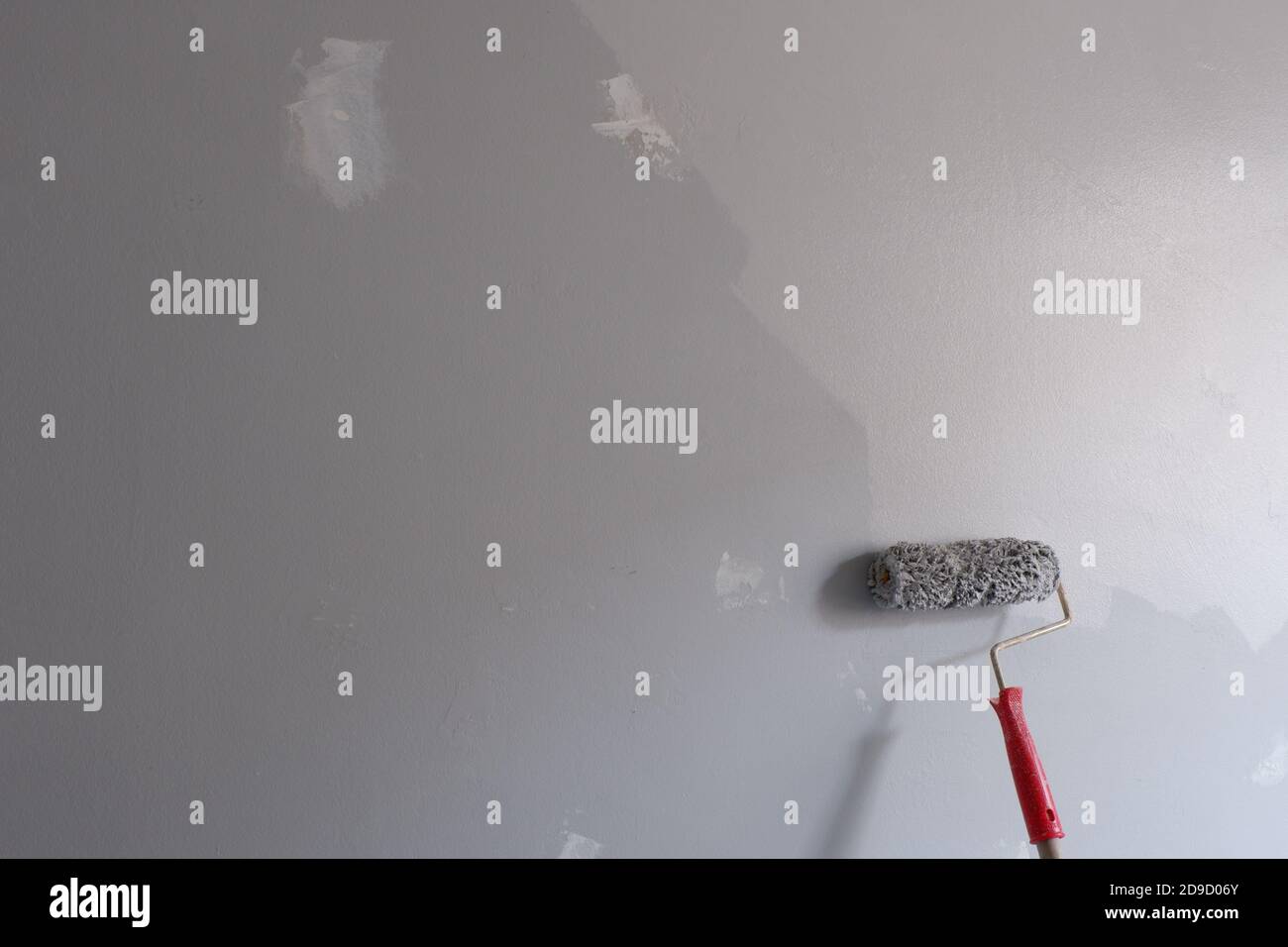 Painting wall with a roller Stock Photo Alamy