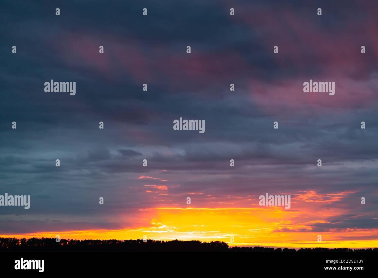 orange sunset over grey cloudy sky Stock Photo