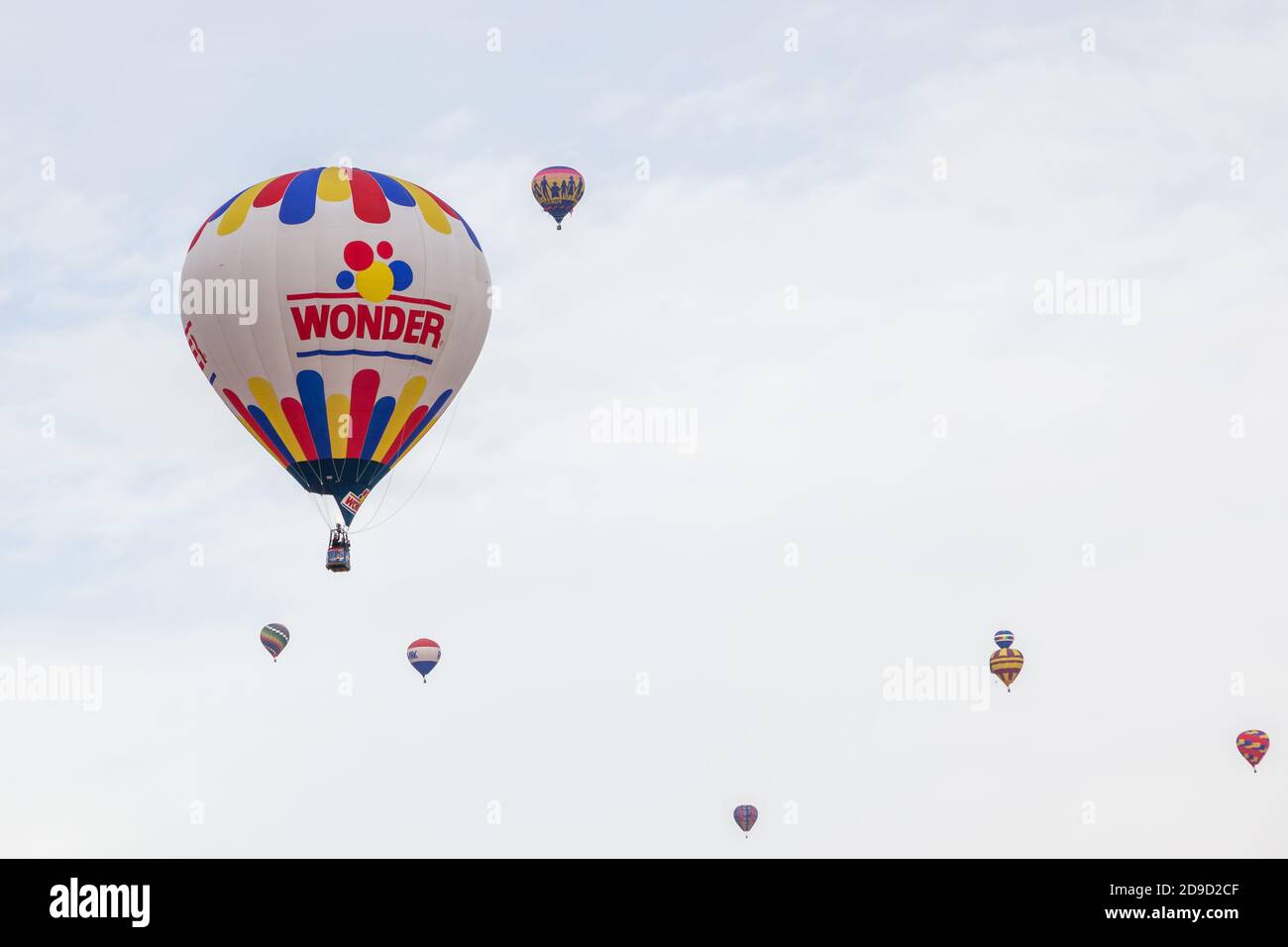 Albuquerque,  New Mexico / USA - October 8, 2014:  The Wonder Bread balloon and several other hot air balloons raising up into a cloudy morning sky at Stock Photo