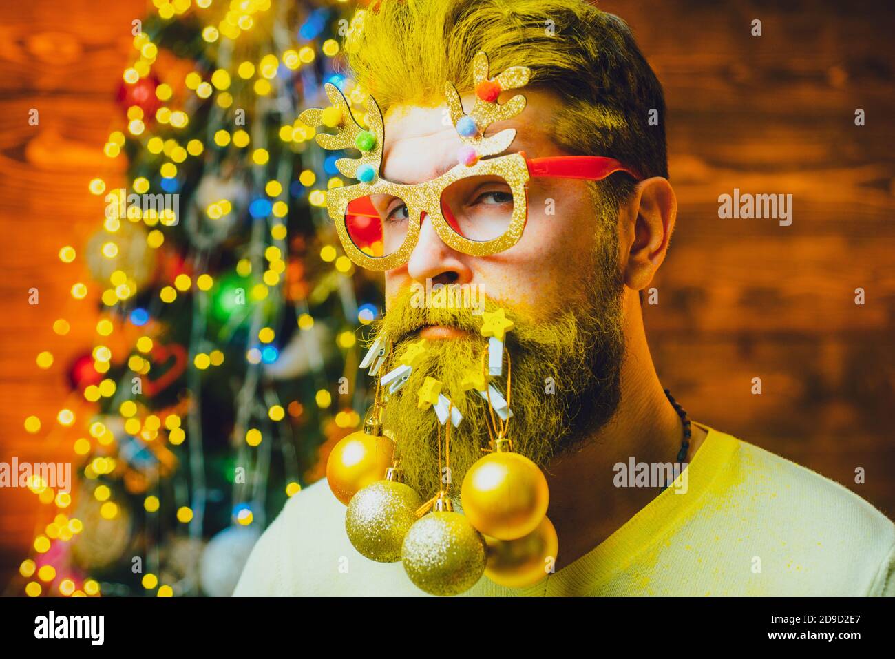 Merry Christmas and happy New Year. Hipster Santa at home. Happy new year. Bearded man in Christmas sweater. Stock Photo