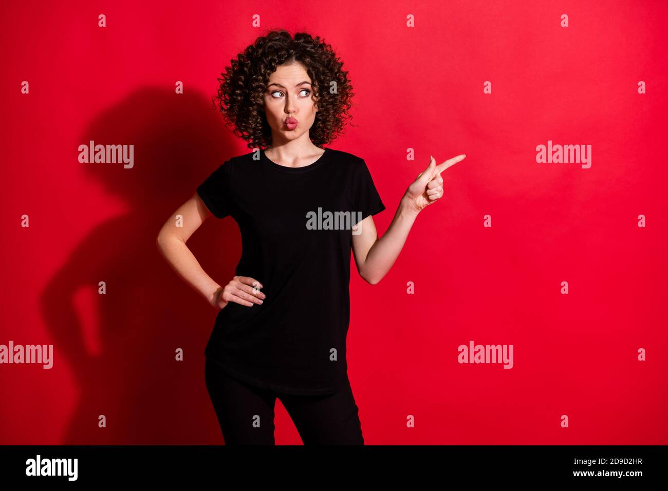 Portrait of pretty cute wavy-haired girl pointing aside copy space pout ...