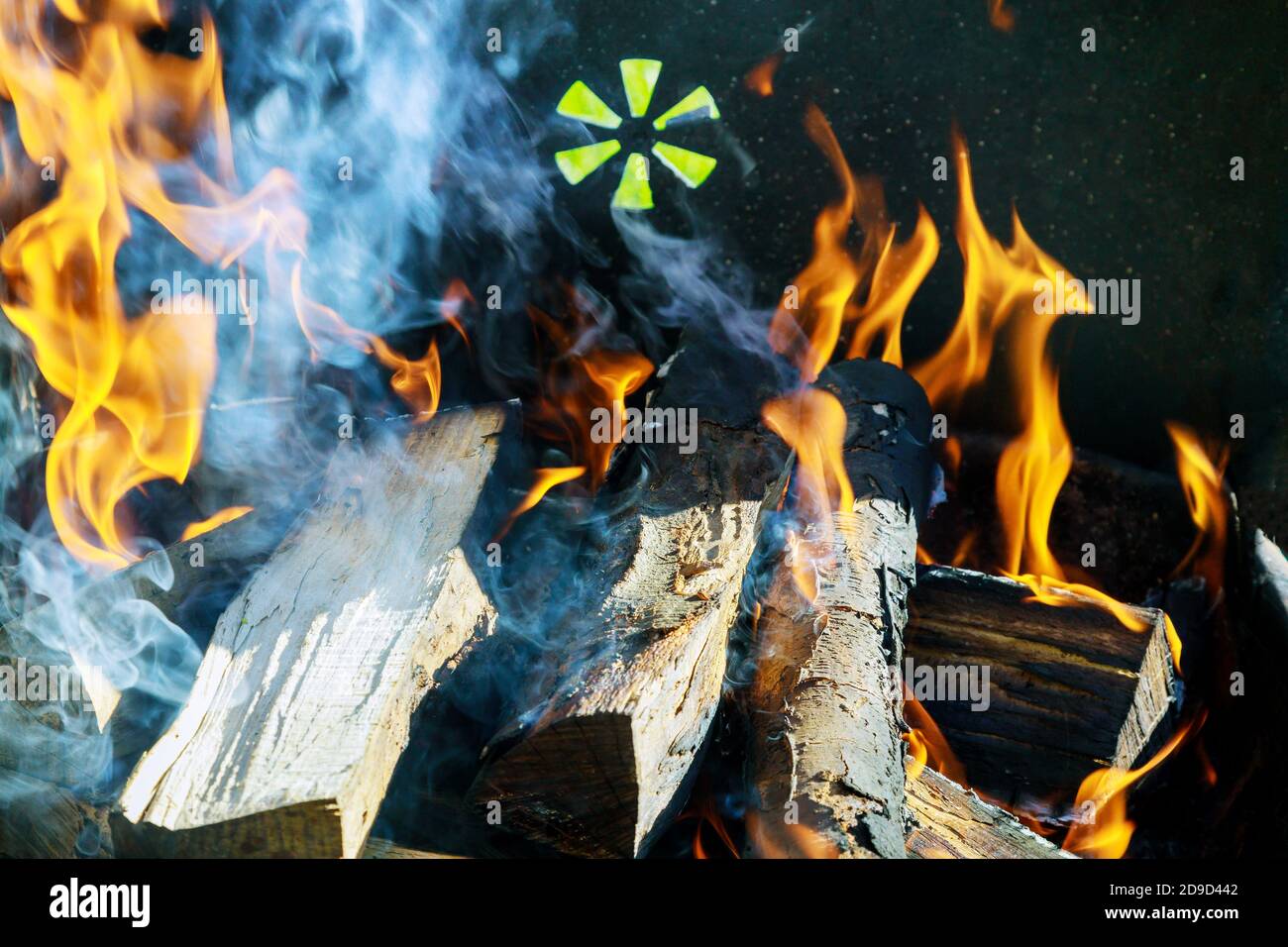 Burning firewood and log in the grill. Close up. Stock Photo