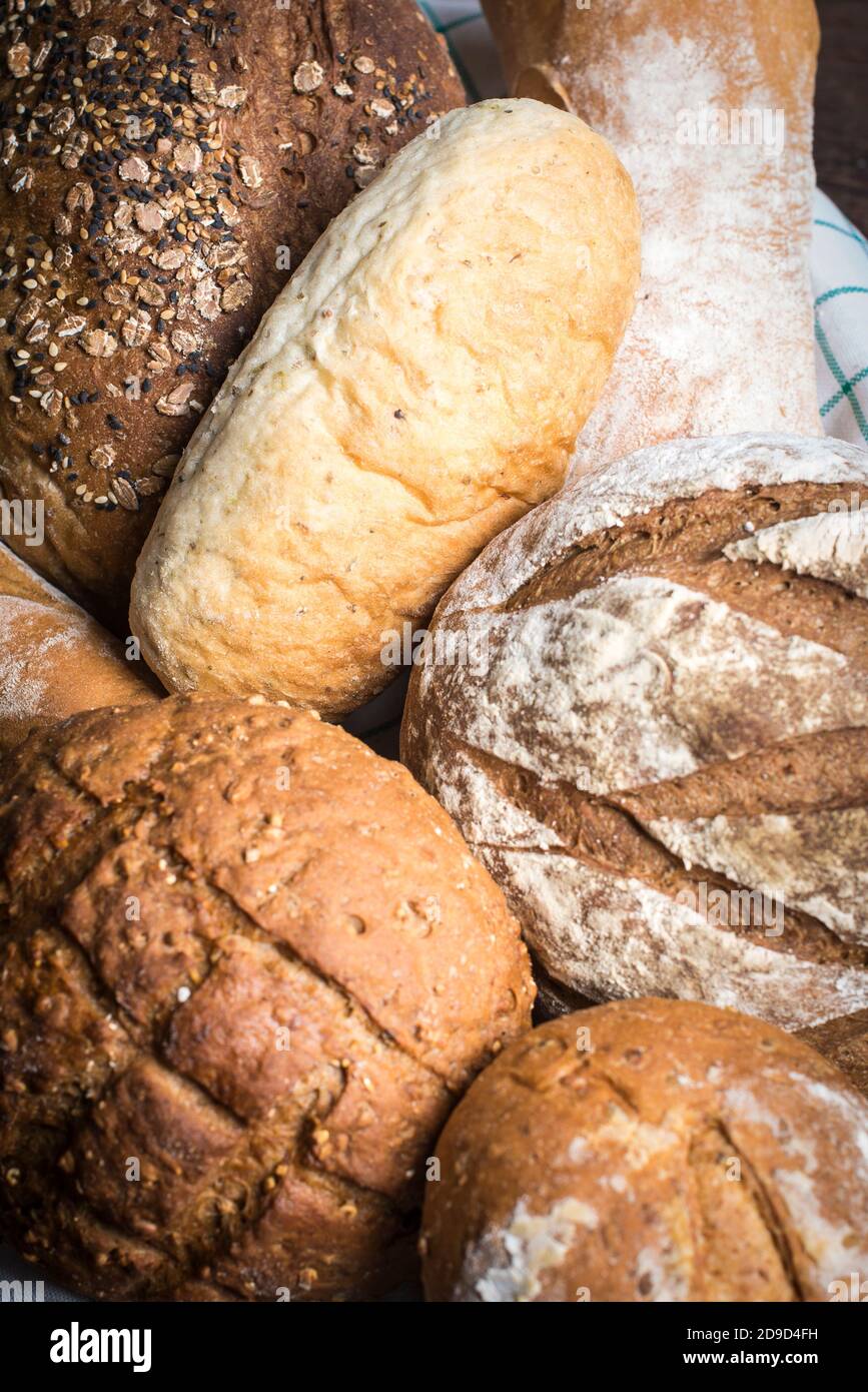 A assortment of different types of artisan bread displayed at a bakery