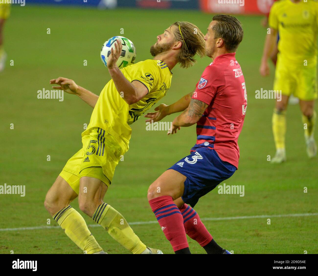 Nashville, TN, USA. 04th Nov, 2020. Nashville defender, Walker Zimmerman (25), traps the ball as Dallas defender, Reto Ziegler (3), waits for the ball during the MLS match between FC Dallas and Nashville SC at Nissan Stadium in Nashville, TN. Kevin Langley/CSM/Alamy Live News Stock Photo