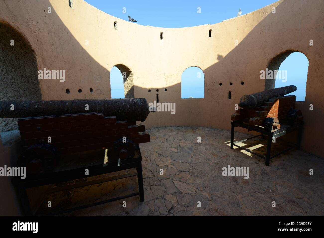 Cannons on a watchtower on the Mutrah corniche guarding the port. Stock Photo