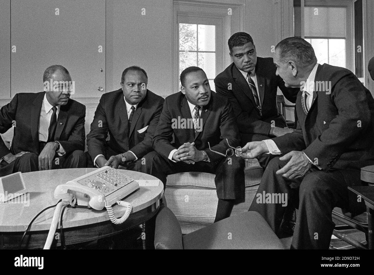 President Lyndon B. Johnson meets with civil rights leaders in the Oval Office of the White House in January 1964. From left, Roy Wilkins, executive director of the NAACP; James Farmer, national director of the Congress of Racial Equality; Martin Luther King, Jr., president of the Southern Christian Leadership Conference; and Whitney Young, executive director of the National Urban League. Stock Photo