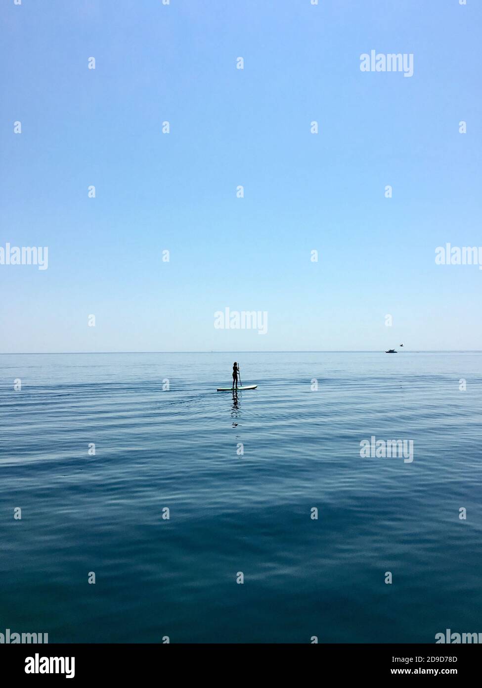 Sup board. water sport. a young man stands on a board in the sea Stock Photo