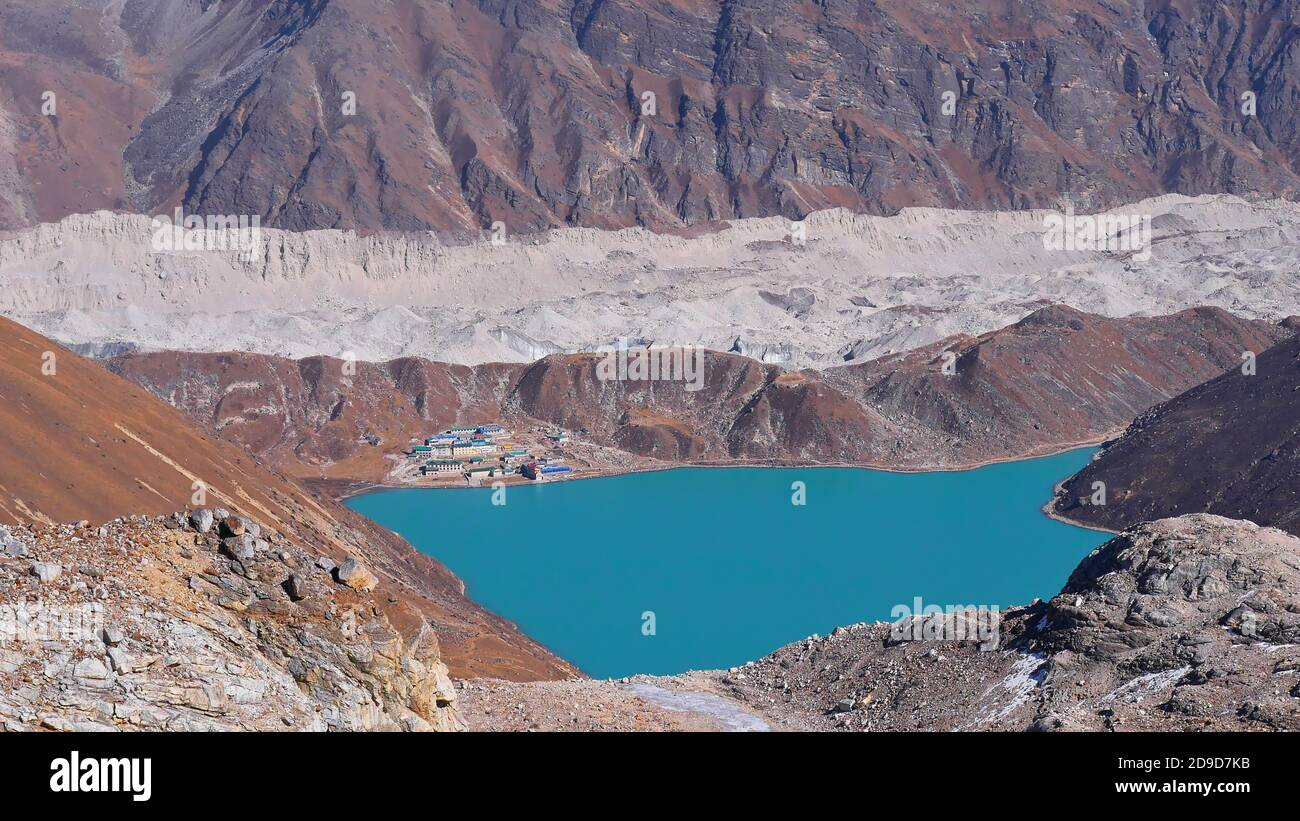 Aerial view of Sherpa village Gokyo (4,860 m) located on the shore of third lake with majestic Ngozumpa glacier in background seen from Renjo La Pass. Stock Photo