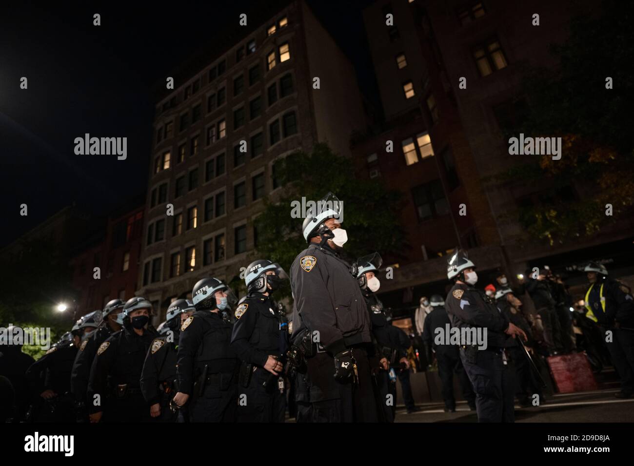 New York, New York, US. Nov 4th 2020. As the US awaits election results, New York City police officers line up for crowd control duty while several hundred anti-Trump protesters march through New York City's Greenwich Village neighborhood Stock Photo