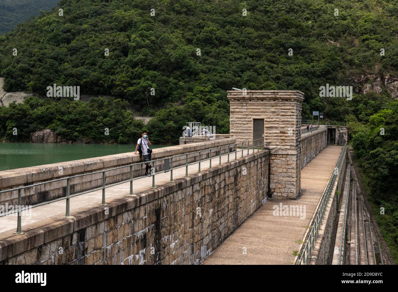 Hong Kong,China:23 Aug,2020.  Tai Tam Upper Reservoir bridge and valve house on the dam.Hiking in Hong Kong is a very popular pastime fueled more by w Stock Photo