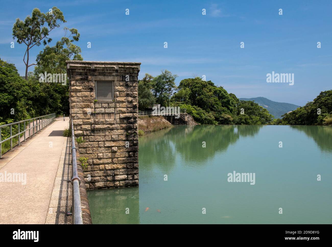 Hong Kong,China:23 Aug,2020.  Tai Tam Upper Reservoir bridge and valve house on the dam.Hiking in Hong Kong is a very popular pastime fueled more by w Stock Photo