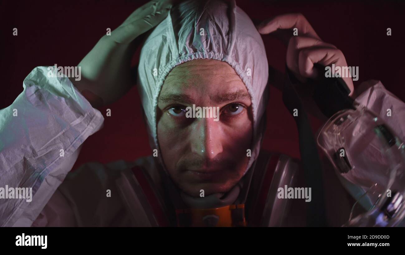 Man in protective costume suit, gas protect medical spray paint mask