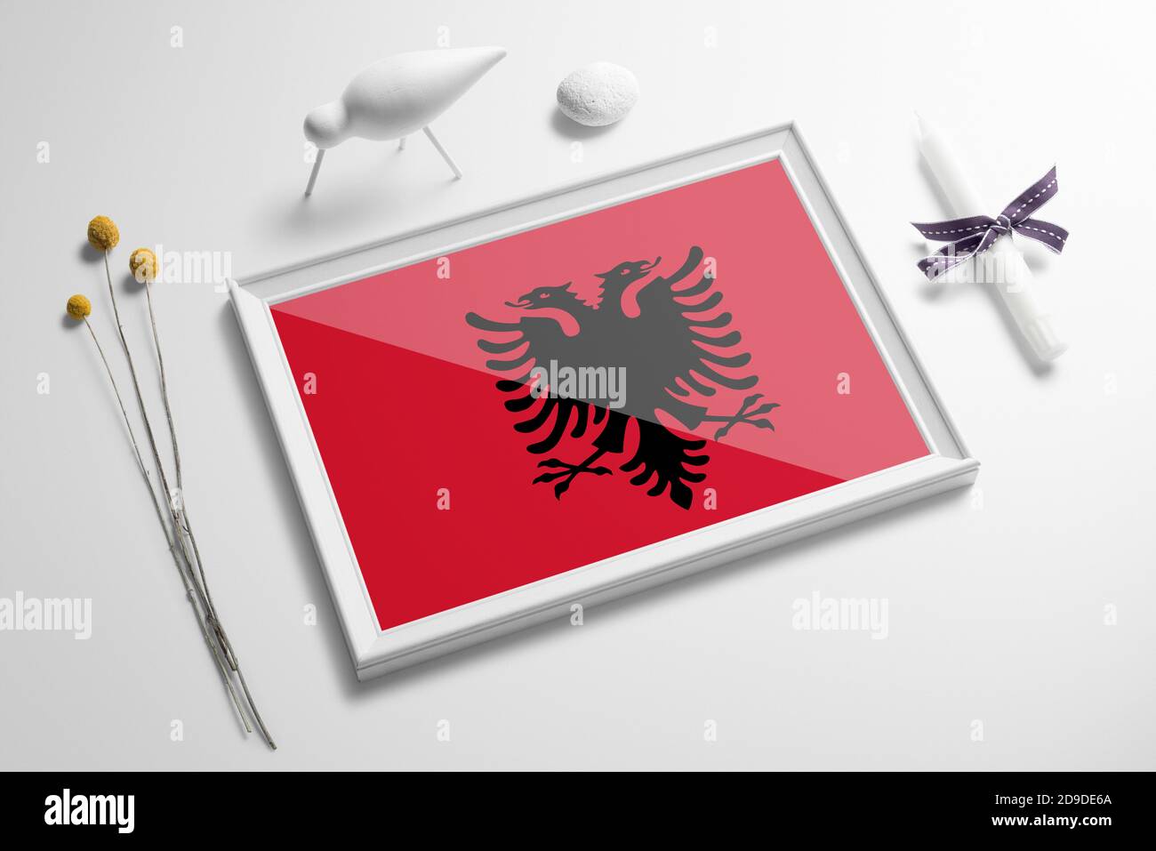 Albania flag in wooden frame on table. White natural soft concept, national celebration theme. Stock Photo