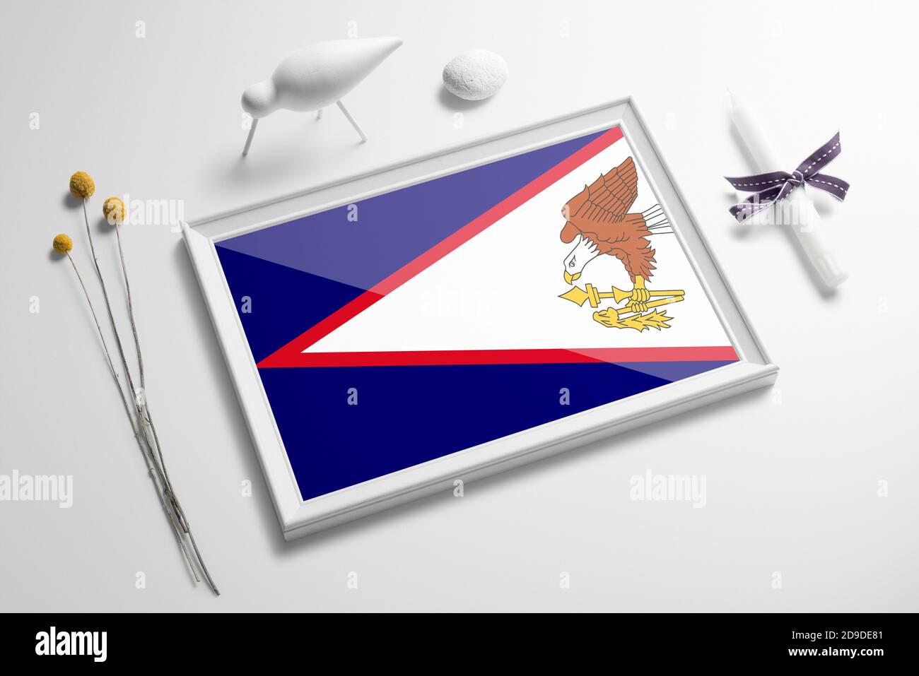 American Samoa flag in wooden frame on table. White natural soft concept, national celebration theme. Stock Photo