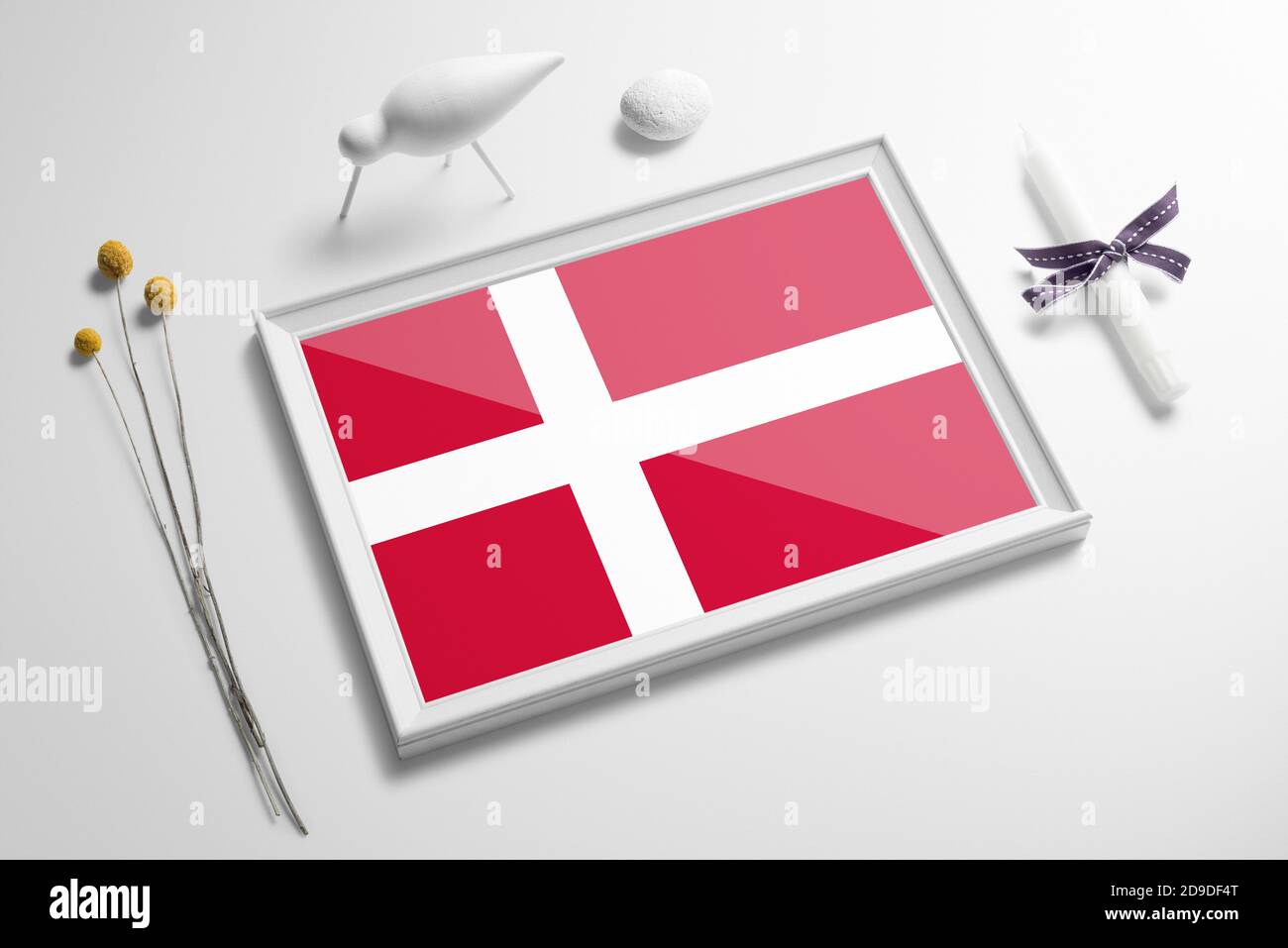 Denmark flag in wooden frame on table. White natural soft concept, national celebration theme. Stock Photo