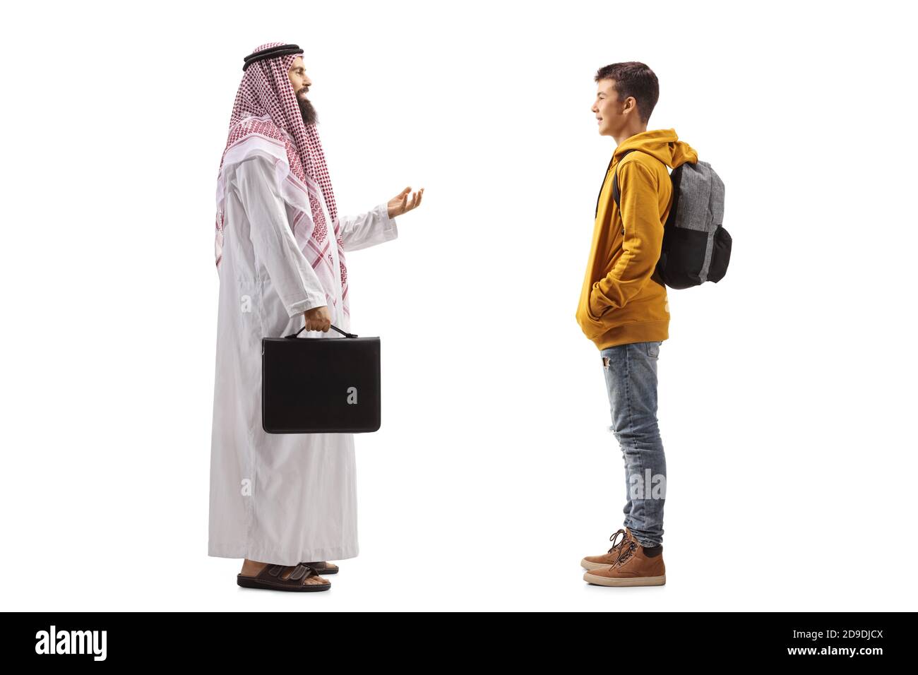 Full length profile shot of an arab man in a traditional thobe talking to a teenage schoolboy isolated on white background Stock Photo