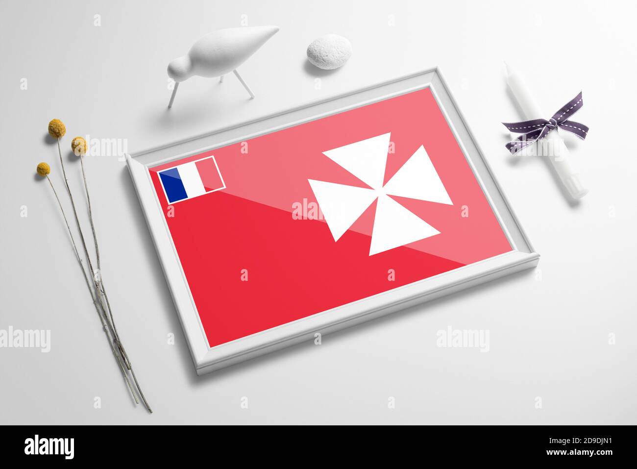 Wallis And Futuna flag in wooden frame on table. White natural soft concept, national celebration theme. Stock Photo