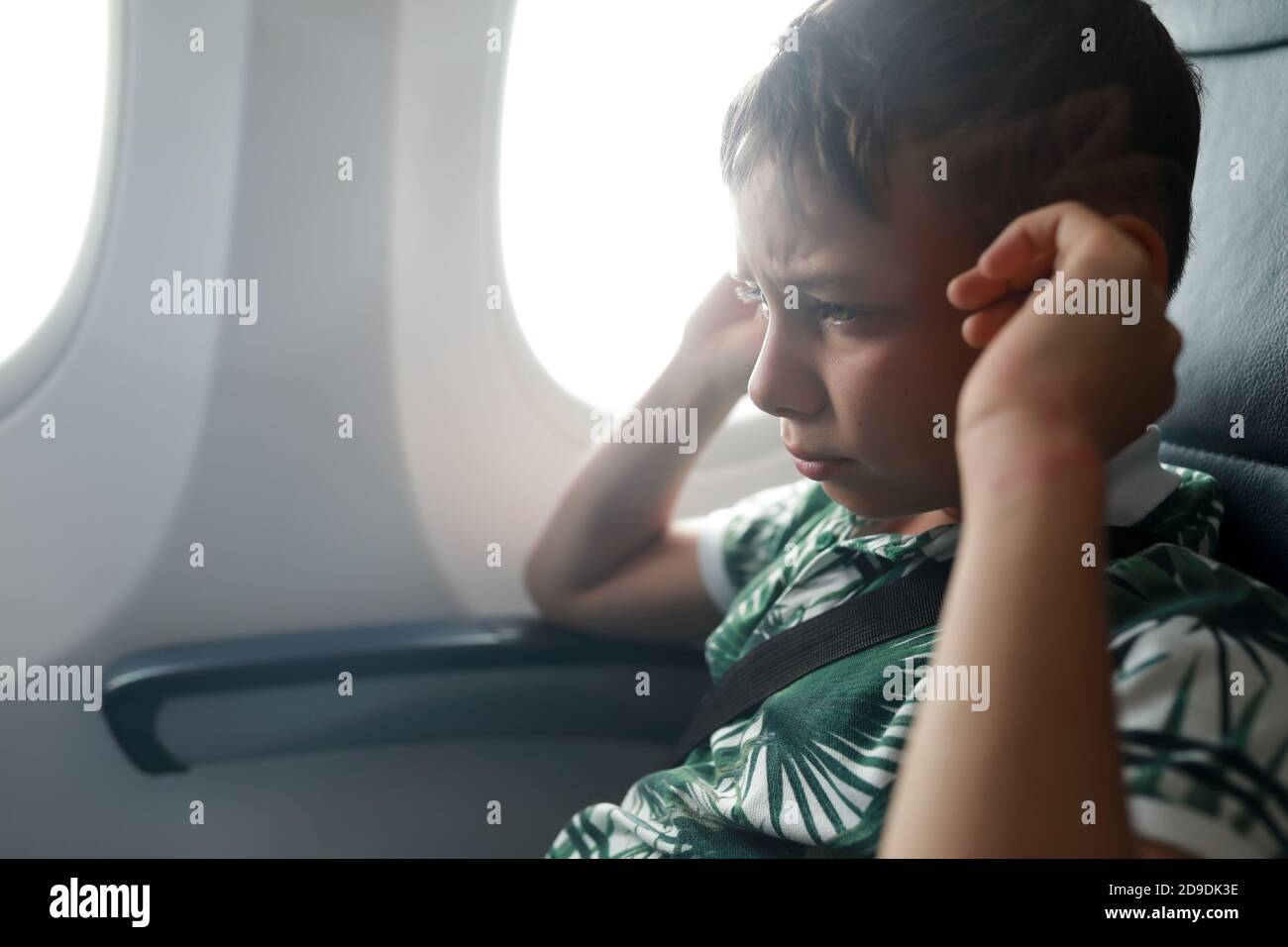Child has ear pains about plane landing in flight Stock Photo Alamy
