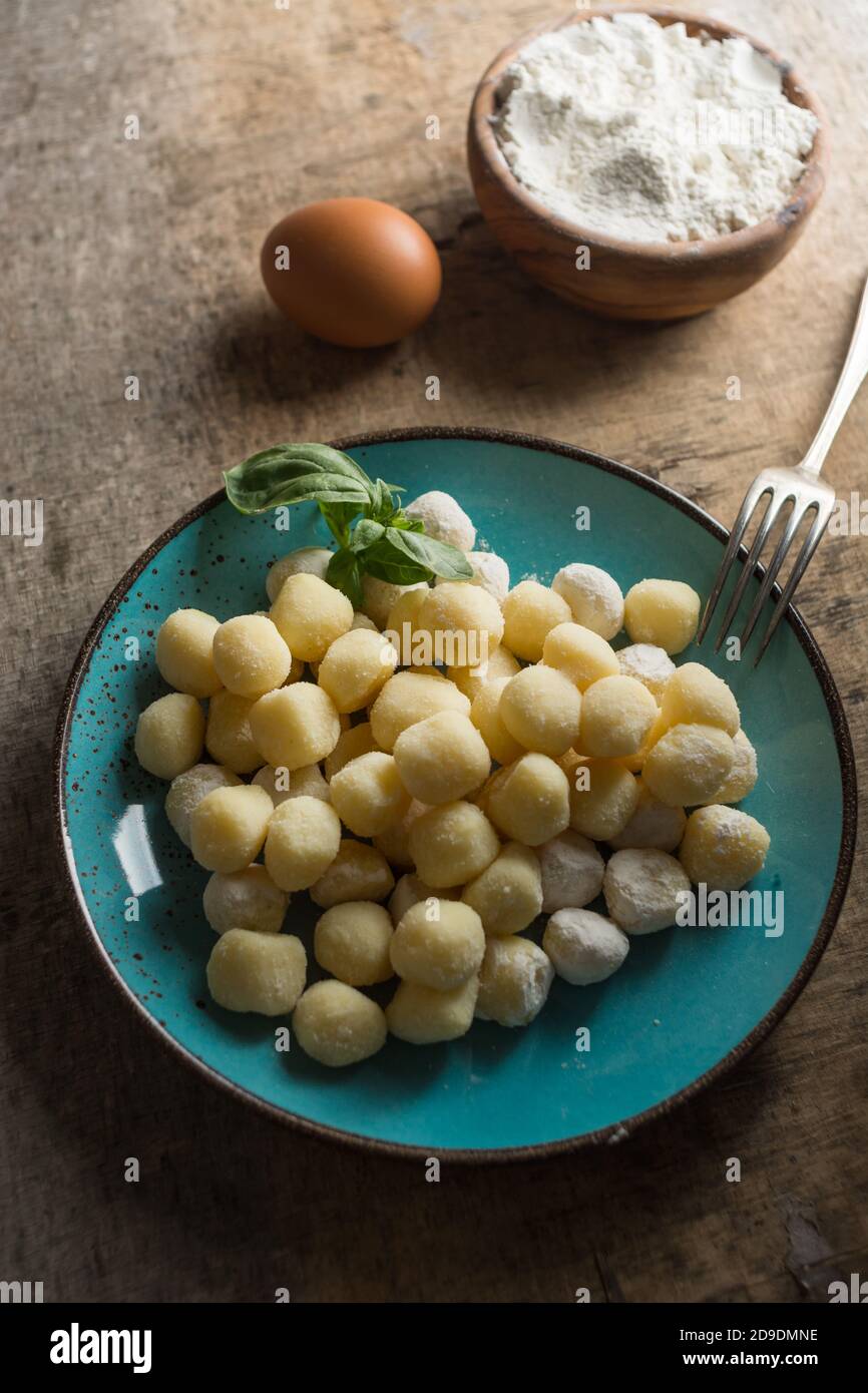 Raw gnocchi, typical Italian made of potato, flour and egg dish. Perfect meal to accompany with a sauce. Stock Photo