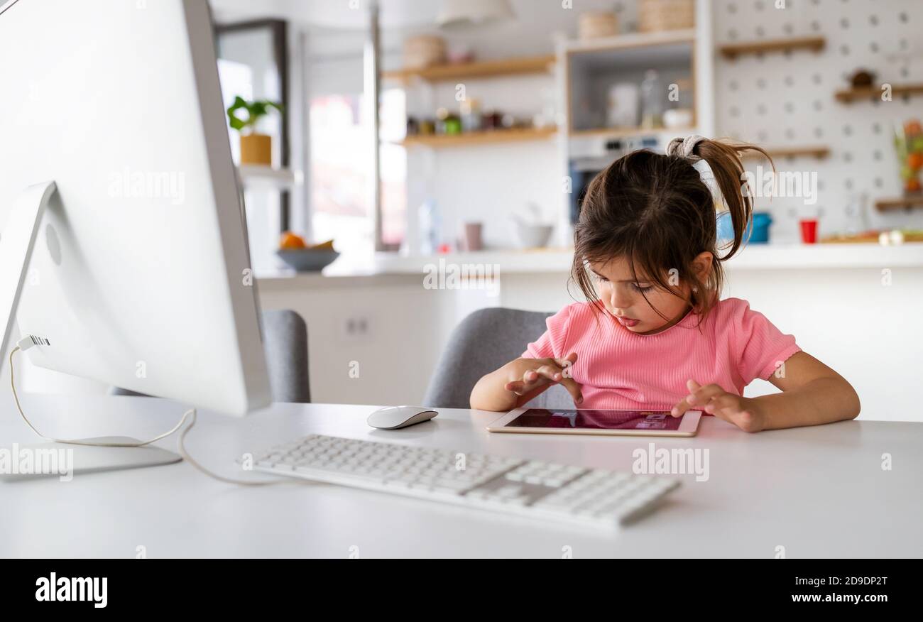 Young girl playing video games on computer after online school and  homework. Gamer using shooting action play for entertainment and fun with  keyboard and monitor. Child enjoying game Stock Photo - Alamy