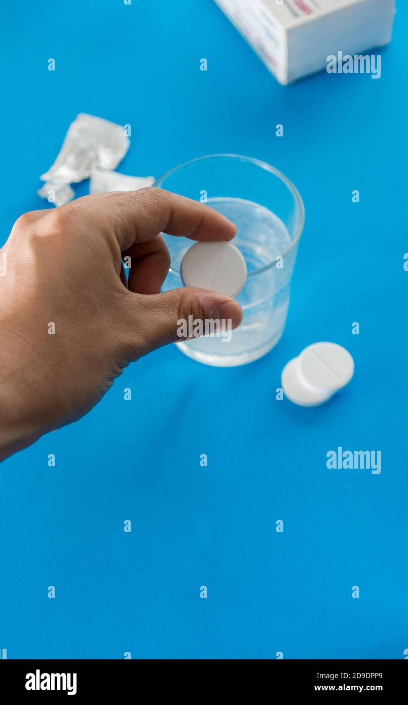 Several types of pills, such as antibiotics, anti-inflammatories. All on blue background Stock Photo