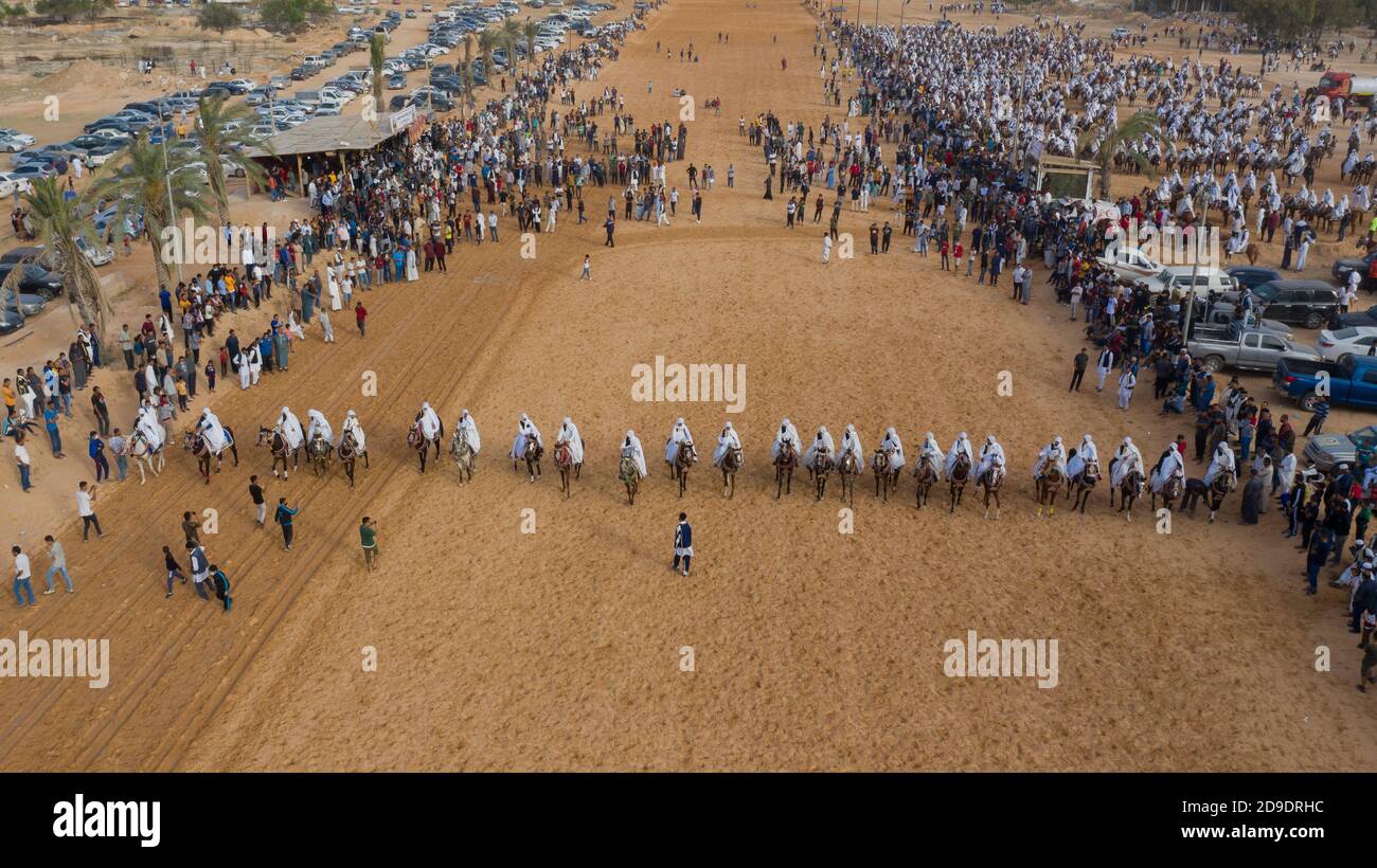 Group of horsemen Participate in a traditional festival of Horses racing show at one of the wedding party in Janzour city in Libya Stock Photo