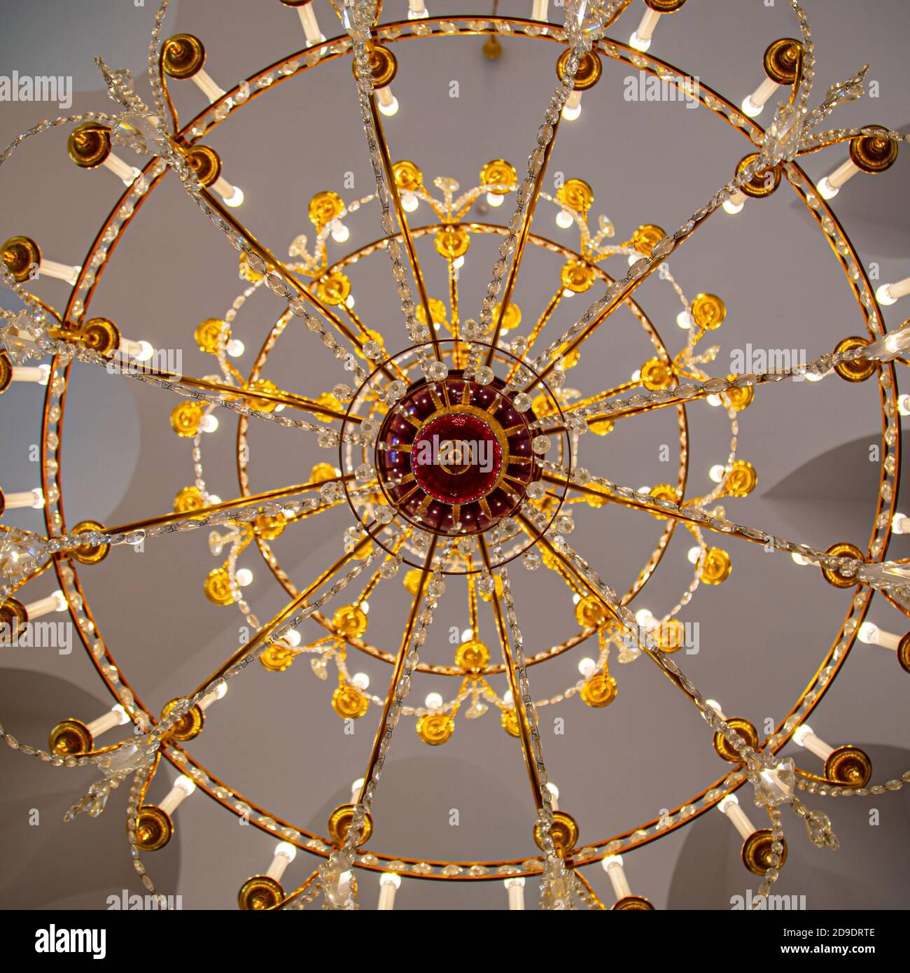 A chandelier from bottom view with colorful ceiling as background Stock Photo