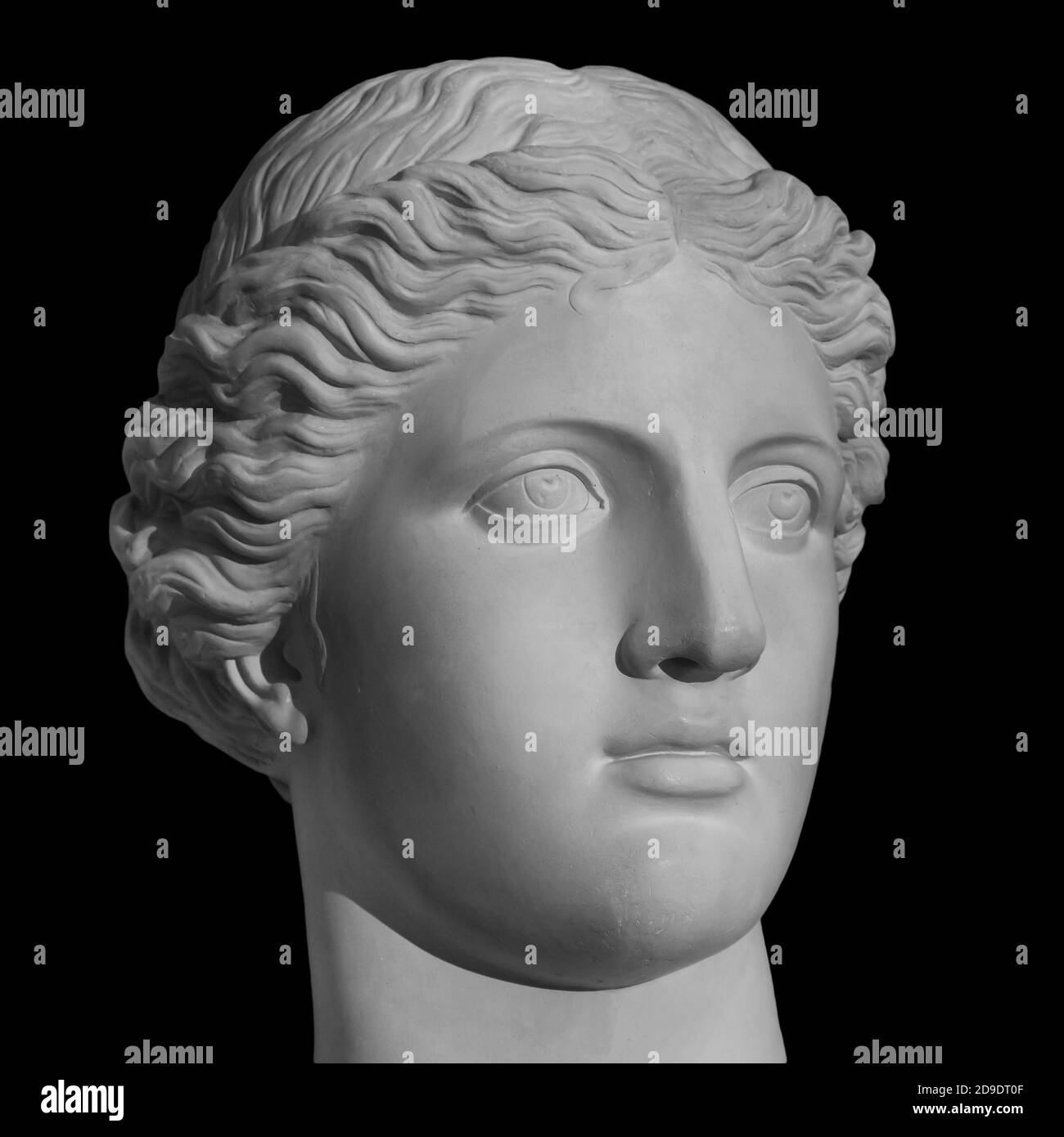 Ancient statue Venus head isolated on black background. Plaster antique