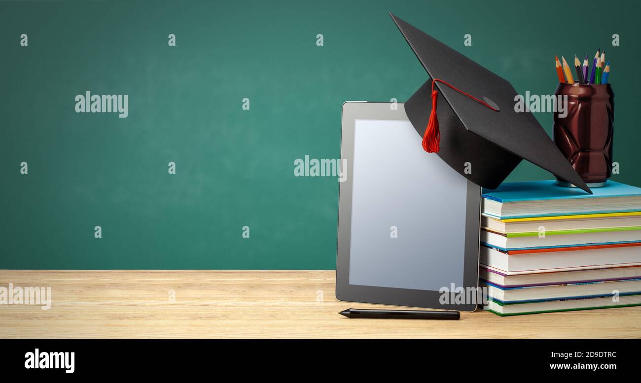 Online education. Distance learning at home. Tablet and stack of books ...