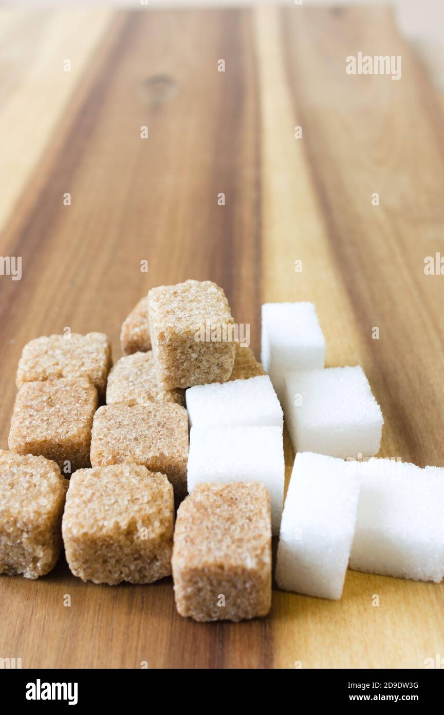 Cube of white and brown sugar on wooden table Stock Photo