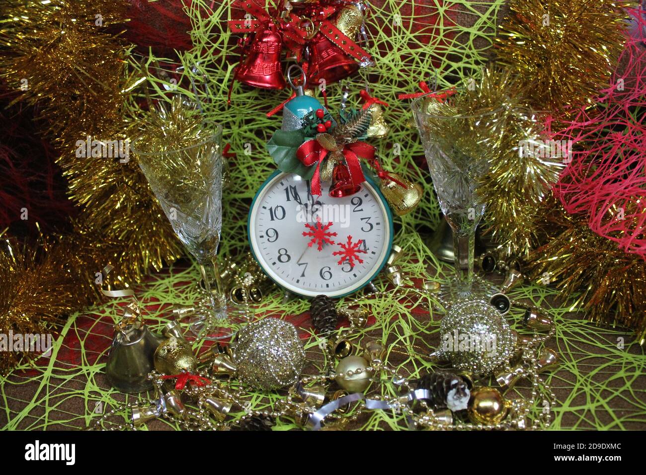 tinsel, sparks, wineglasses, clock, balls, bells, beads, decoration for Christmas and New Year holiday Stock Photo