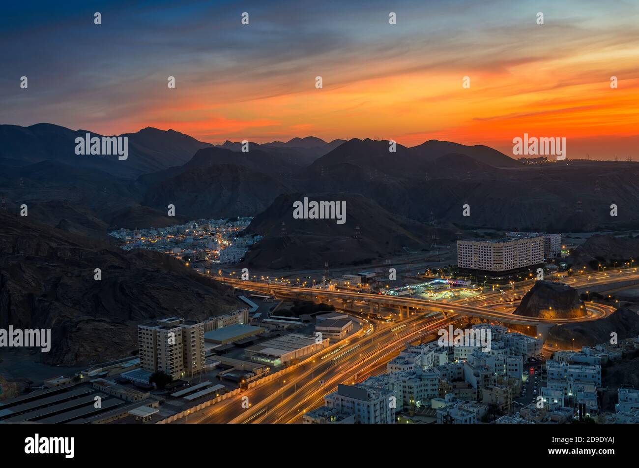 Beautiful Orange sky over Muscat city in the evening. Shot from a hilltop. Stock Photo