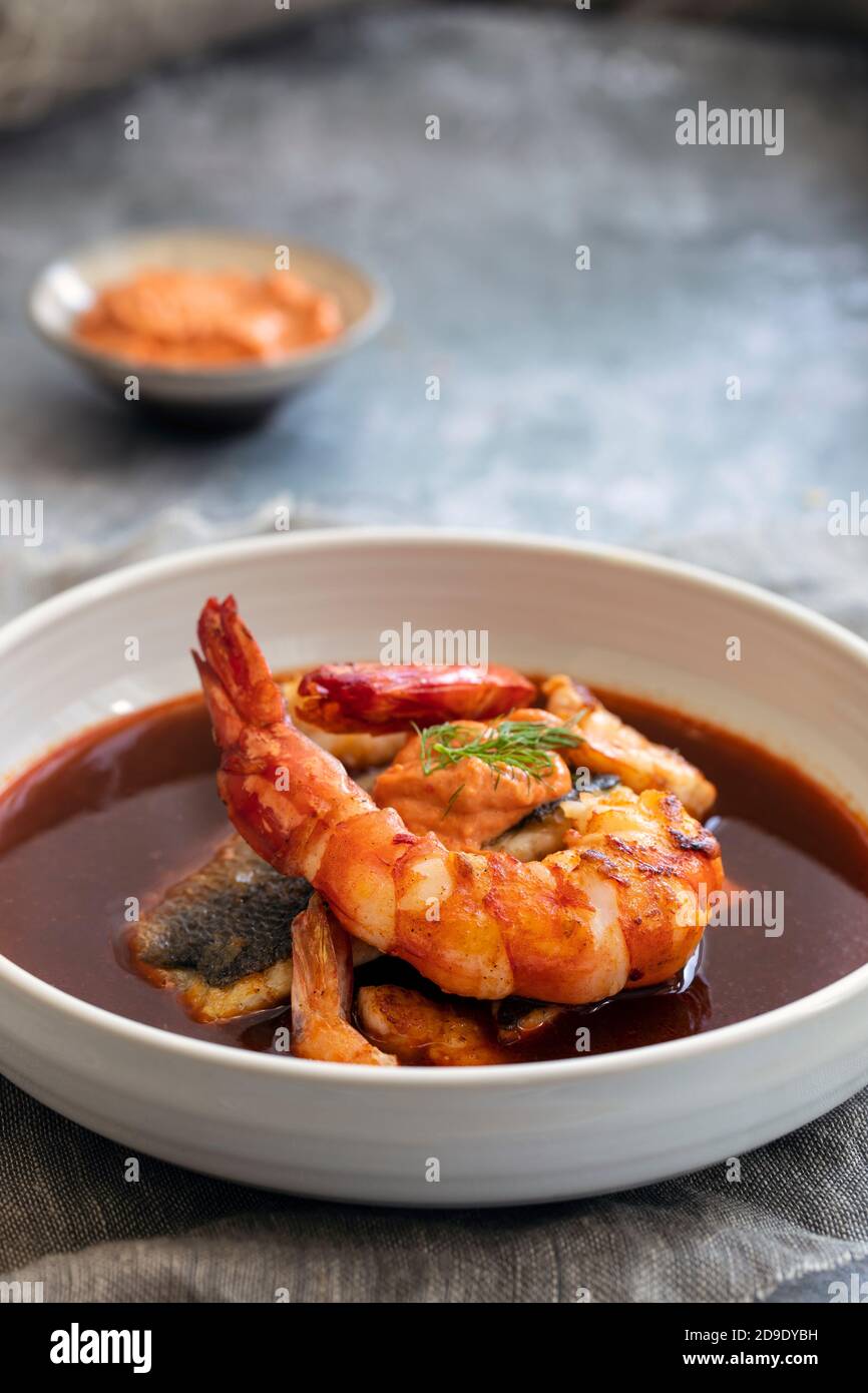 Bouillabaiss, French fish soup with sea bass and prawns Stock Photo